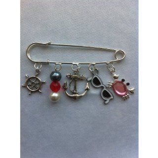 Divine Beads Nautical Themed Brooch, Ready to wear. Contains 5 themed charms: Ships Rudder, Nautical Colours Bead Charm, Anchor Charm, Sunglasses and Rhinestone Crab CharmBr. Easily attached you can mix and match with our entire collection. All purchases f