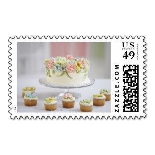 cake with flower icing and cupcakes postage stamp