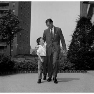 Father walking with son with arm around him Poster Print (18 x 24)